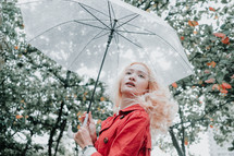 a woman standing under an umbrella