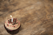 chocolate cupcake and candle 