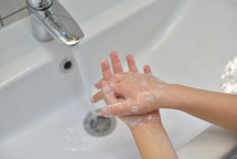 Washing hands in a sink 