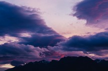 storm clouds at sunset over mountain peaks 