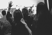 congregation with raised hands during a worship service 