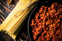 Bolognese sauce with pasta . On a rustic background