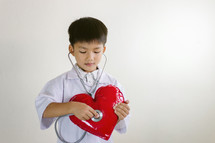 kid with a stethoscope and heart 
