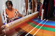 a woman weaving on a loom 