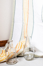 glass vases and striped curtain 