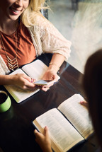 women reading Bibles and discussing scripture 