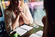 women at a Bible study praying 