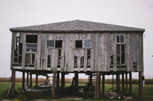 an old abandoned house on stilts 