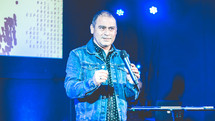a pastor on stage giving a sermon 