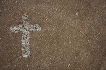  cross of shells in sand 