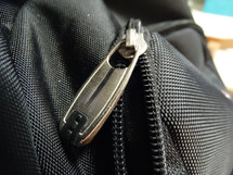 Close up of silver zipper on black bookbag