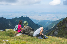 Father with his little girl resting on a mountain top
