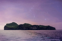 constellations over an island at night 