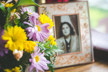 old photograph of a woman and flower arrangement 
