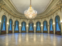 Big castle dancing room with candelabra in th middle. Castle interior. Empty room
