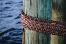 steel metal rope around a pier pillar 