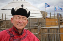 Headshot of a Mongolian man in traditional dress