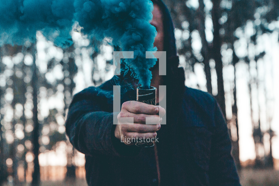 a man holding a smoke flare 