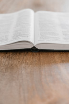 open Bible on a wooden table 