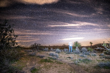a man standing in a desert at night 
