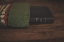 A Bible sticking out of a stocking on wood