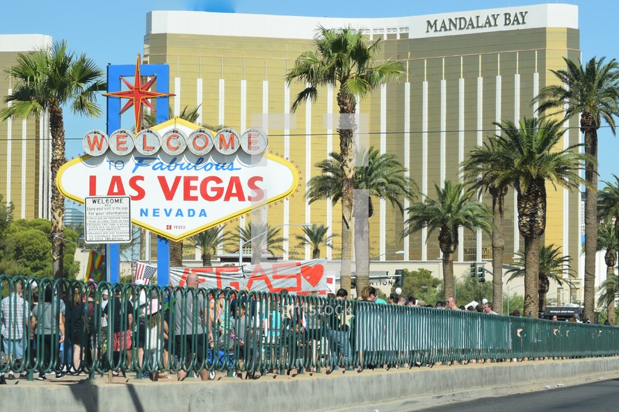people visiting the Las Vegas sign after the mass shooting to pay respect to the fallen victims 