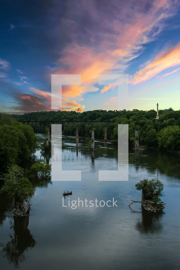 bridge over still water at sunset 