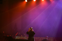 a woman singing on stage 