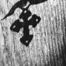 shadow of a cross on wood 