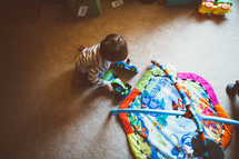 toddler boy playing with toys 