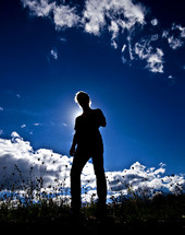 silhouette of a man under a cobalt blue sky 