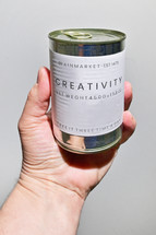Man Holding Tin Metal Can. Concept Creativity Label Prescription on Tin Metal Can 