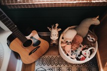 toy basket and guitar 