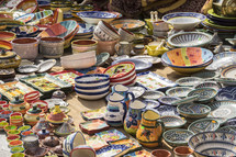 colorful bowls and porcelain pitchers at a market 
