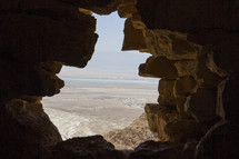 view of the holy land through the mouth of a cave 