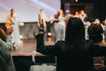 Woman with her hands raised during worship.