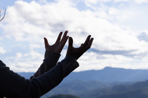 Woman praying and worshiping in the mountains