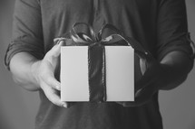 man handing a gift. black and white