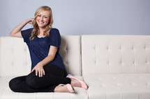 woman sitting on a white couch 