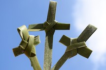 three palm crosses against the sky for Palm Sunday or Easter 