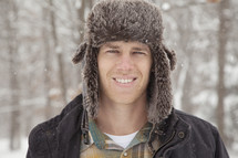 Man in a winter hat outdoors.