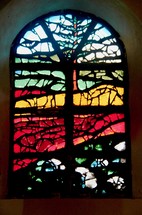Stained glass window in the Notre Dame Des Laves Church, surrounded by volcanic lava.