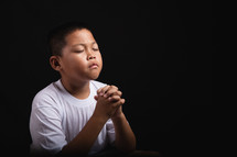 Boy praying to God 