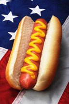 hotdog with mustard on an American flag 