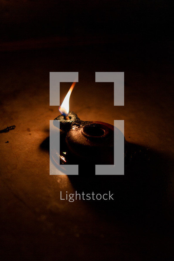 a flame in a clay lantern 