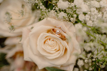 Close up of a wedding bouquet with rings.