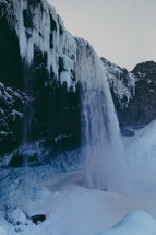 icicles on a mountainside and waterfall 