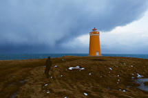 orange lighthouse and stormy sky 