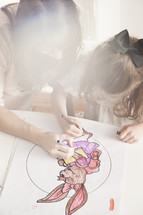 mother and child coloring an easter bunny picture 