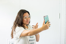 a young woman taking a selfie 